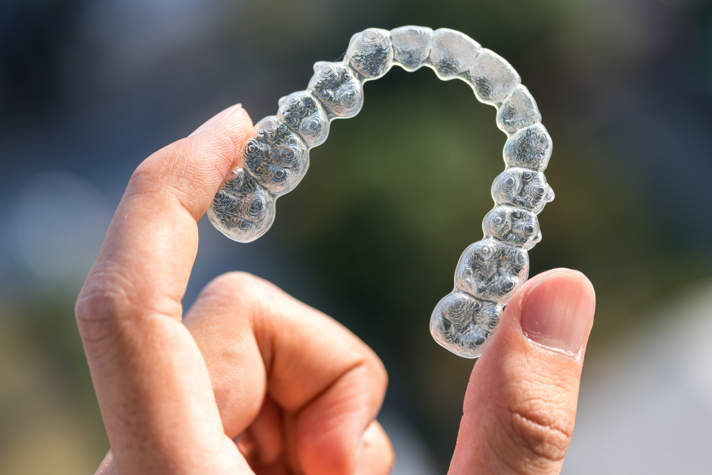 clear aligners being held into an bright enviroment