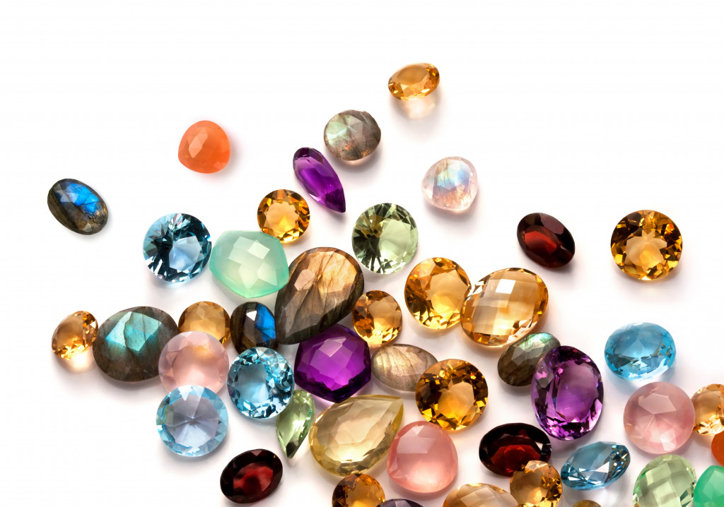 Collection of many different natural gemstones on white background