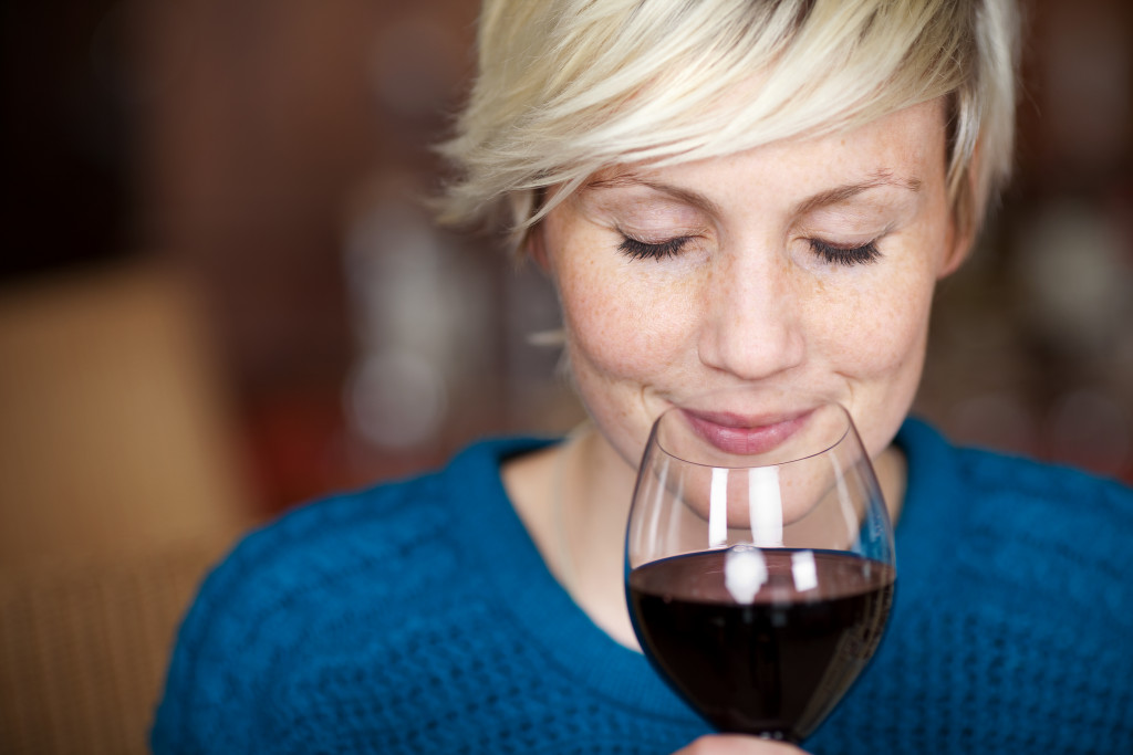 woman smelling her wine