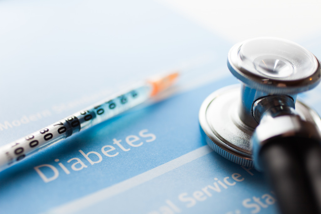 A diabetes test, stethoscope, and syringe