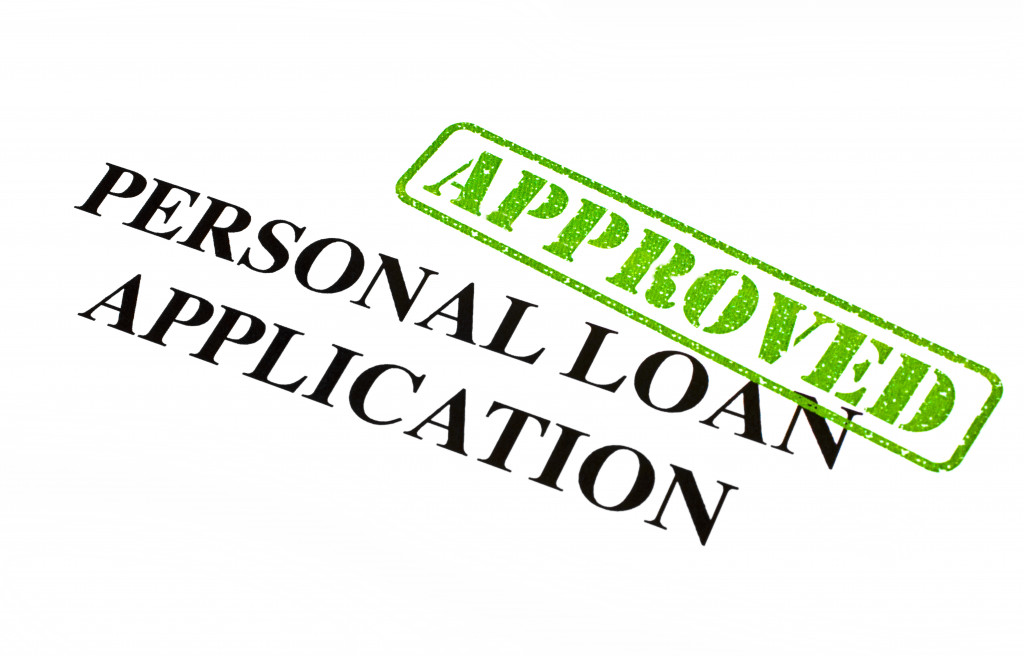 A personal loan application with a green approved stamp